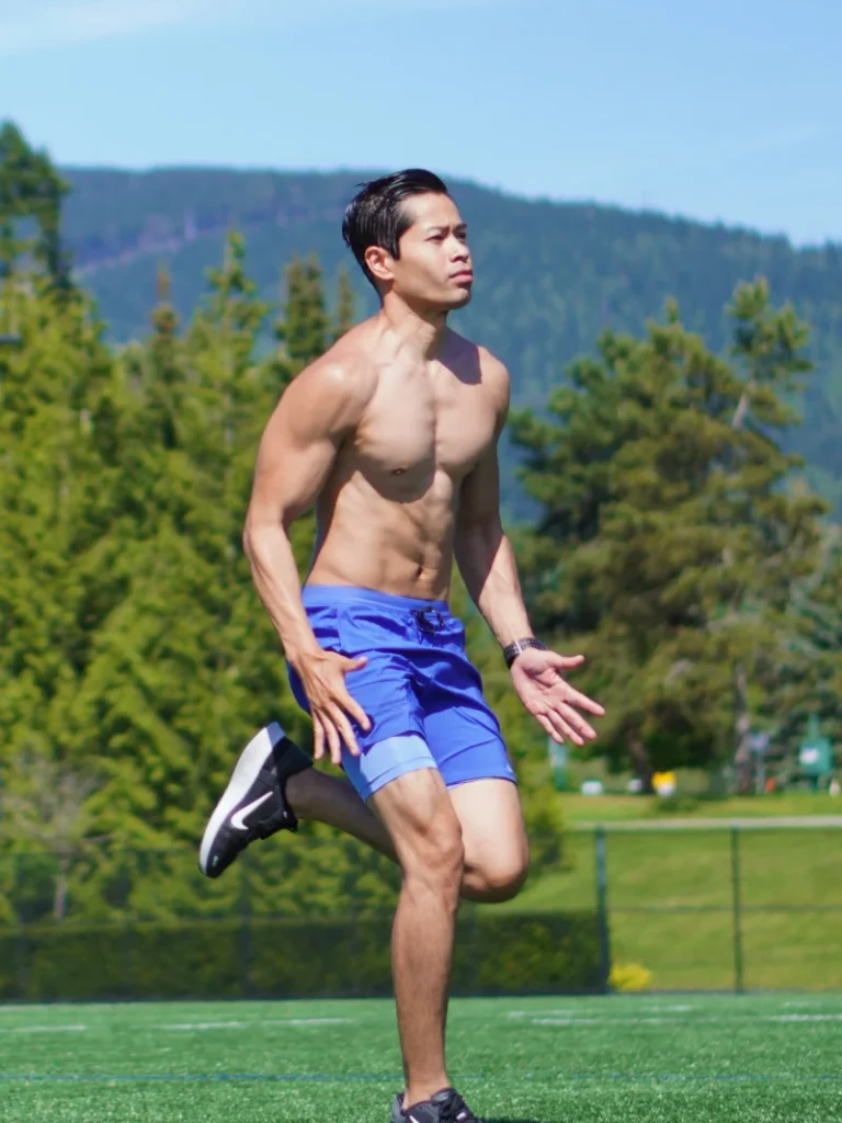 Personal trainer and kinesiologist Tee Live from Tee Live Fitness And Kinesiology running outdoors on a sunny day at the park.