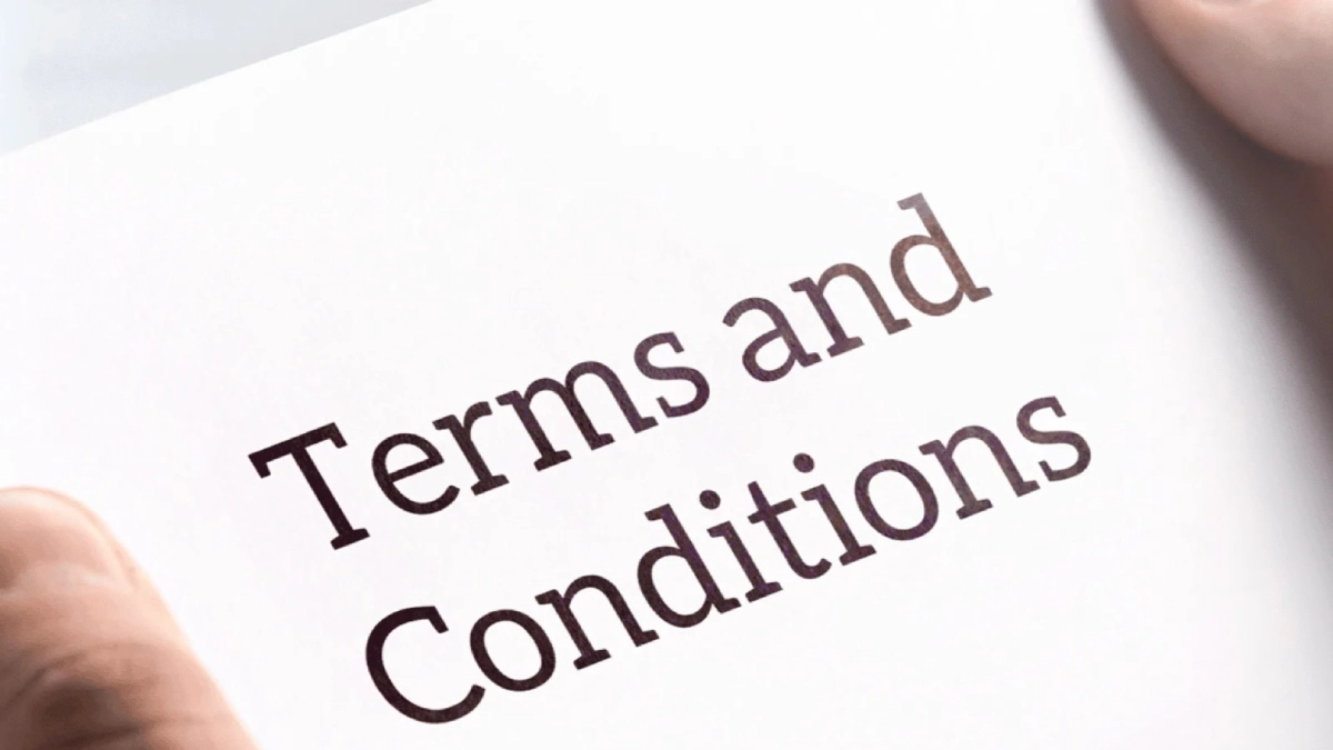 Man holding a page that says terms and conditions.